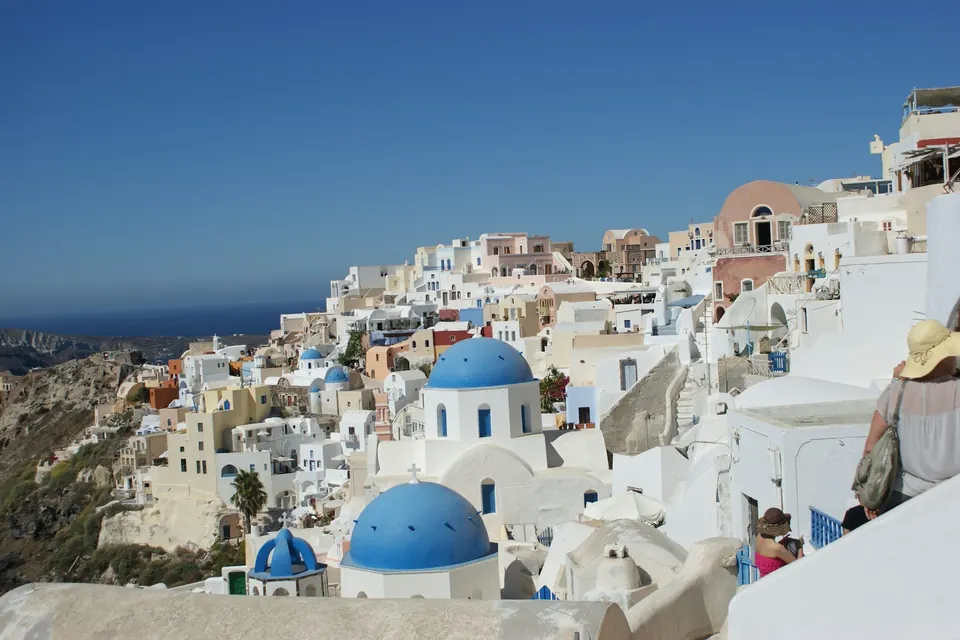 Before: Santorini view with three tourists in the corner