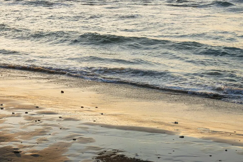 After: the same beach at sunset with no people